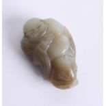 An oriental green jade carving of an man in gown, length 7cm.