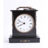 A small black mantle clock of antique design, with key.