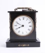A small black mantle clock of antique design, with key.