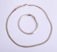 A 9ct gold necklace and bracelet, approximately 12g, cased.