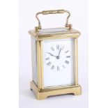 Modern carriage clock, brass case, Roman numerals, height 15cm, handle up.