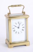 Modern carriage clock, brass case, Roman numerals, height 15cm, handle up.