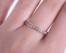 An 18ct white gold full band diamond eternity ring, size P/Q.