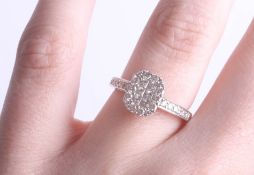 An 18ct diamond set ring, pave set with six princess cut diamonds within a border of thirteen round