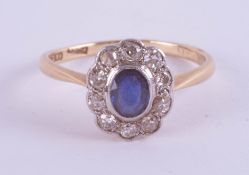 An 18ct sapphire and diamond cluster ring, set in yellow gold, size O.