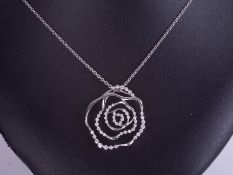 A 18ct and diamond set swirl pendant and chain, approximately 1ct of total diamond weight.