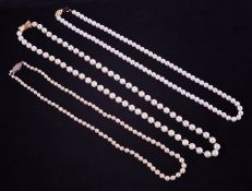 Three strings of pearls, with silver and gold clasps, with a Mikimoto cultured pearl box.