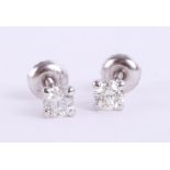 A pair of 14k white gold round cut diamond stud earrings, colour D-E, clarity VS1, total carat