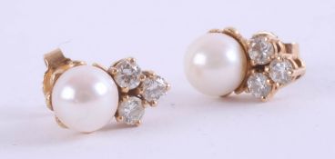 A pair of pearl and diamond set earrings, set in unmarked yellow gold, in original box (purchased in
