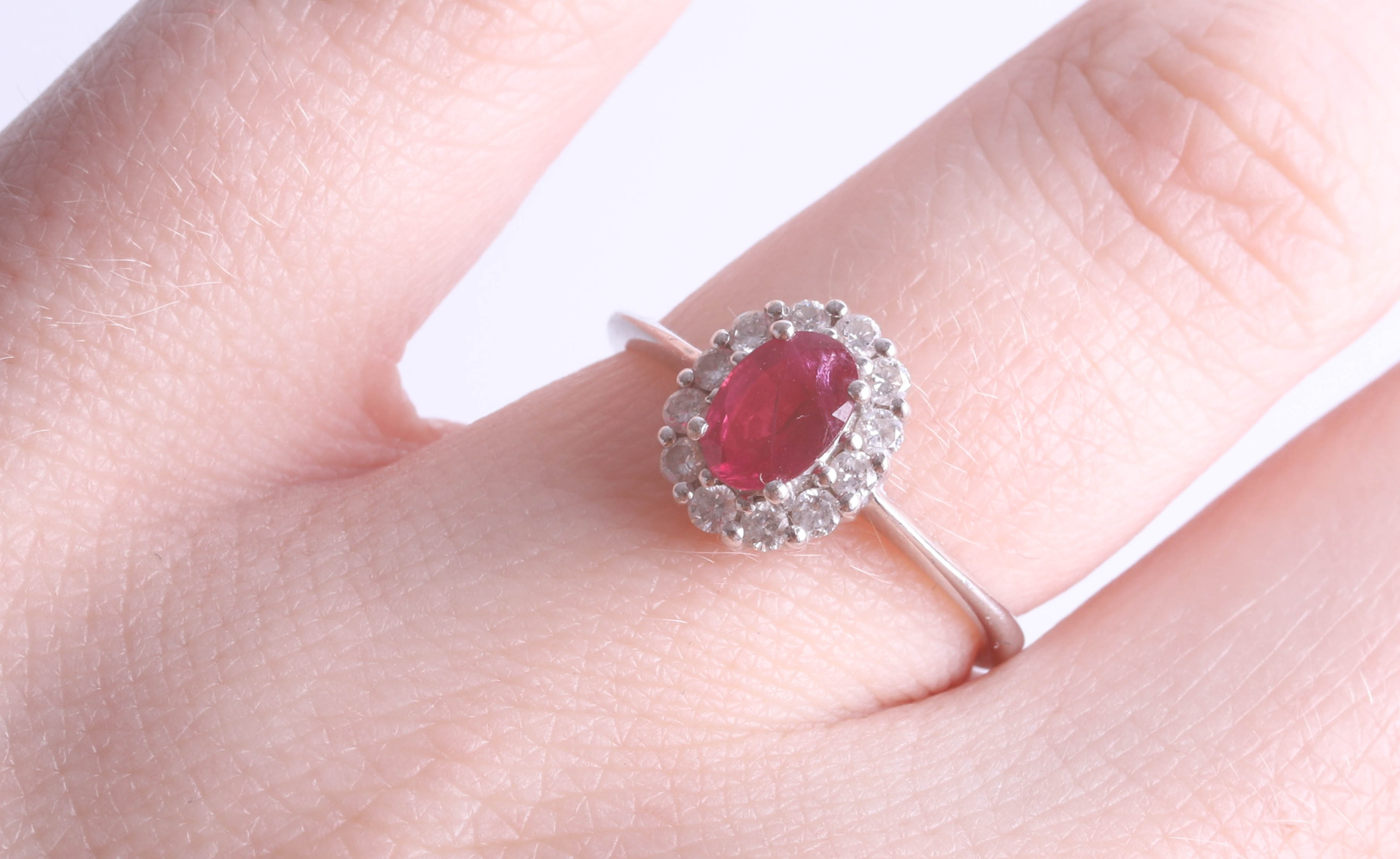 An 18ct white gold ruby cluster ring, size K.