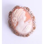 A large 9ct gold oval cameo brooch, depicting a period lady with floral hair decoration, approx.