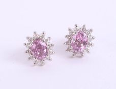 A pair of 18ct pink sapphire and diamond cluster earrings, in white gold.