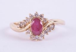 A 14ct modern ruby and diamond oval cluster ring, set in yellow gold, set with 14 round brilliant