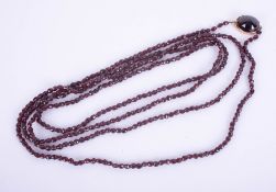 An Edwardian gold and garnet guard chain, length approximately 162cm.