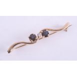 A 9ct sapphire and diamond set brooch, set in yellow gold.