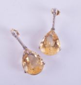 A pair of 18ct citrine and diamond set earrings in white gold.