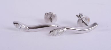A pair 18ct diamond set contemporary earrings.
