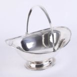 Silver fruit basket with hinged graduated ribbed handle with matching border to bowl and raised oval