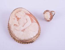 A large 9ct gold cameo shell brooch decorated with a classic figure and an eagle feeding from a
