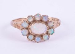 An 18ct modern opal and diamond dress ring, set with seven stones with oval shape, rub over setting,