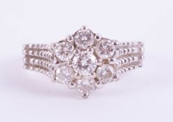 An 18ct diamond cluster ring set in white gold, size J/K.