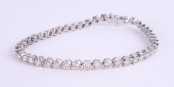 A fine diamond line bracelet, set in platinum, diamond weight approx. 5 carats, set with 46