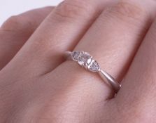 An 18ct white gold three stone diamond ring size P/Q.