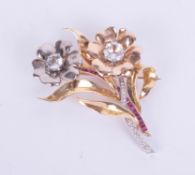 A 18ct three coloured gold diamond, ruby and paste stone flower brooch, width approximately 45mm,