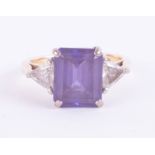 An 18ct emerald cut tanzanite and trillion cut diamond ring, tanzanite total weight 5.78ct, total