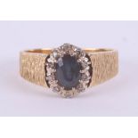 An 18ct yellow gold sapphire and diamond cluster ring, size O.