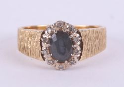 An 18ct yellow gold sapphire and diamond cluster ring, size O.