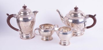 A Geo V silver four piece tea service together with a pair of silver sugar tongs, total weight