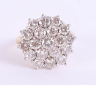 A good 18ct diamond set cluster ring, the head 17mm diameter, set in yellow gold, size O.
