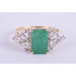An 18ct emerald and diamond ring, the emerald approx 1.00ct,