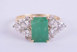 An 18ct emerald and diamond ring, the emerald approx 1.00ct,