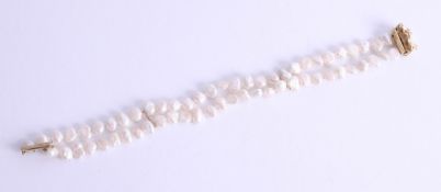 A modern two row fresh water pearl and yellow gold bracelet, average pearl size between 8.5-9mm,