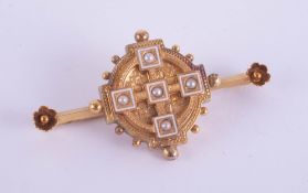 A Victorian yellow metal and seed pearl target brooch with pendant hinge in original box marked