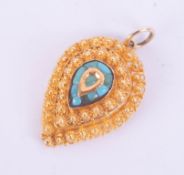 A high carat yellow gold pendant set with turquoise.