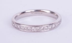 A platinum half band diamond eternity ring, size O.