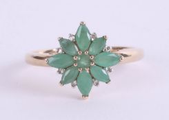 A 9ct emerald and diamond set cluster ring, size P.