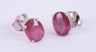 Pair of silver studs set with treated ruby