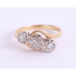 An 18ct diamond three stone ring, size L.