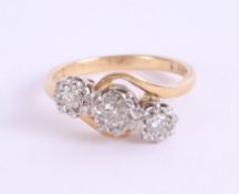 An 18ct diamond three stone ring, size L.