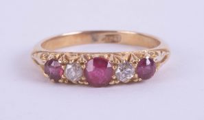 An early 20th century 18ct ruby and diamond five stone ring, set in yellow gold, size M.