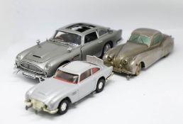 Three models, Kolner Jaguar German, Recent Corgi 007 Aston Martin DB5, with another Aston Martin