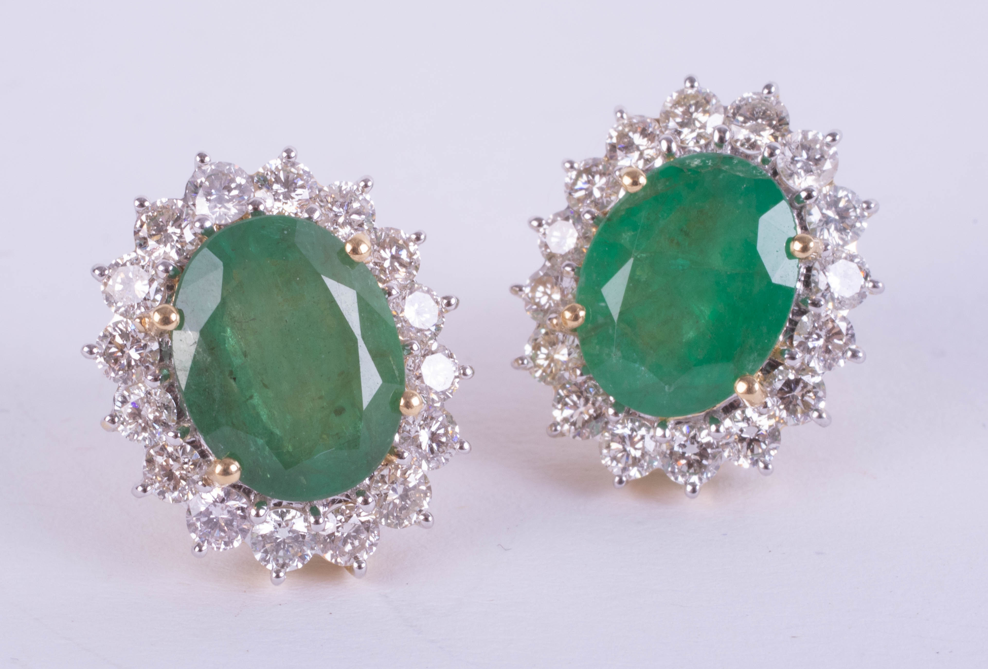 A large pair of 18ct yellow gold emerald and diamond cluster stud earrings, boxed, emerald weight