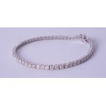 A fine diamond line bracelet set in 18ct white gold, approximately 5.50ct total diamond weight,