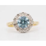 An 18ct blue zircon and diamond set cluster ring, size N.