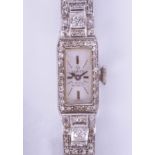 An 18ct ladies diamond set cocktail watch in white gold, the dial marked 'Verity, 17 Jewels,