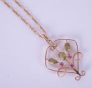 A peridot pendant necklace on fine chain.